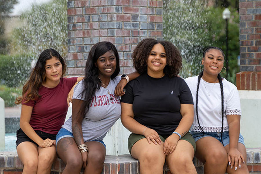 Picture of FSU students sitting at fountain.
